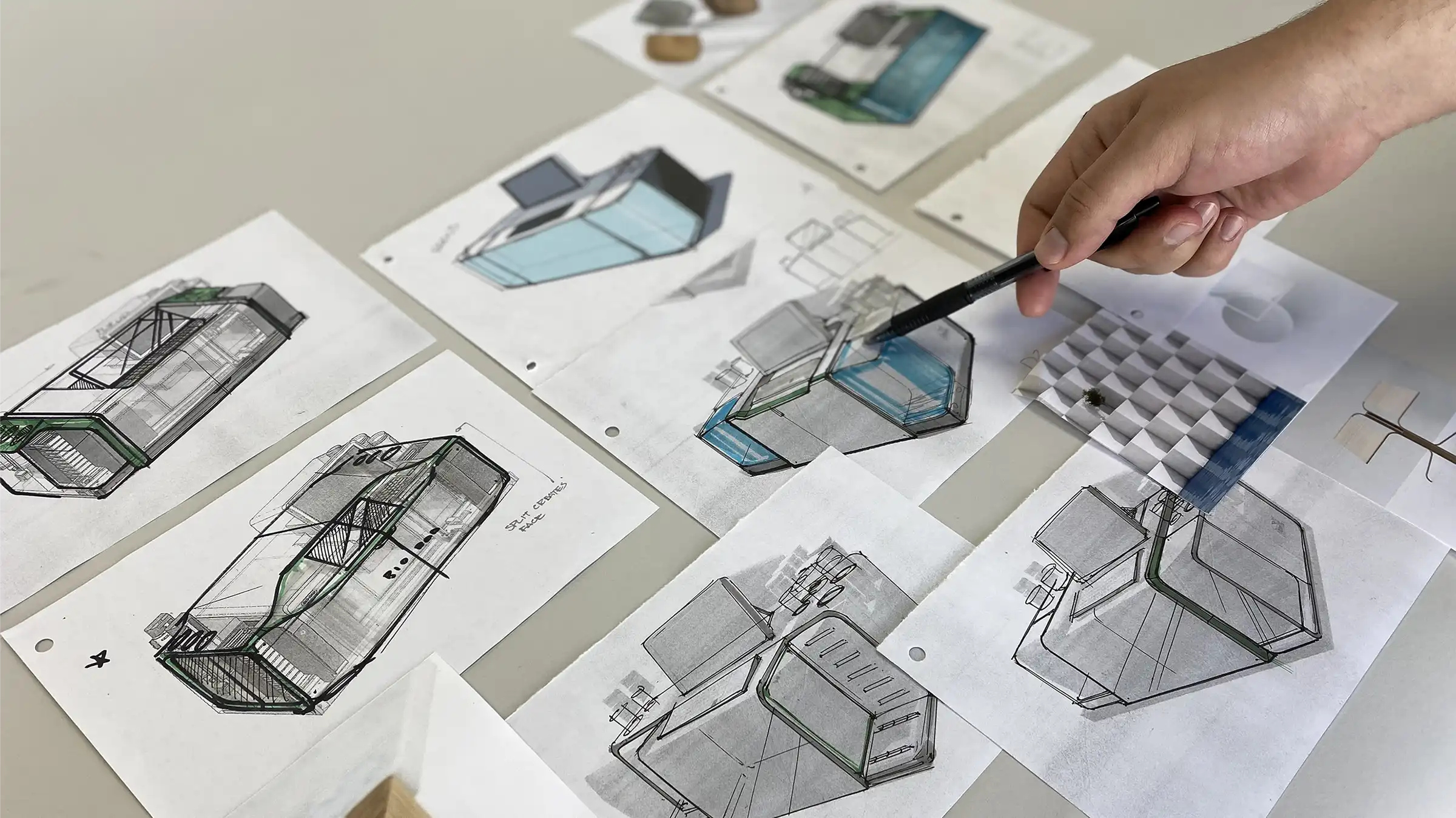 Designer evaluating concept sketches for a biotech instrument