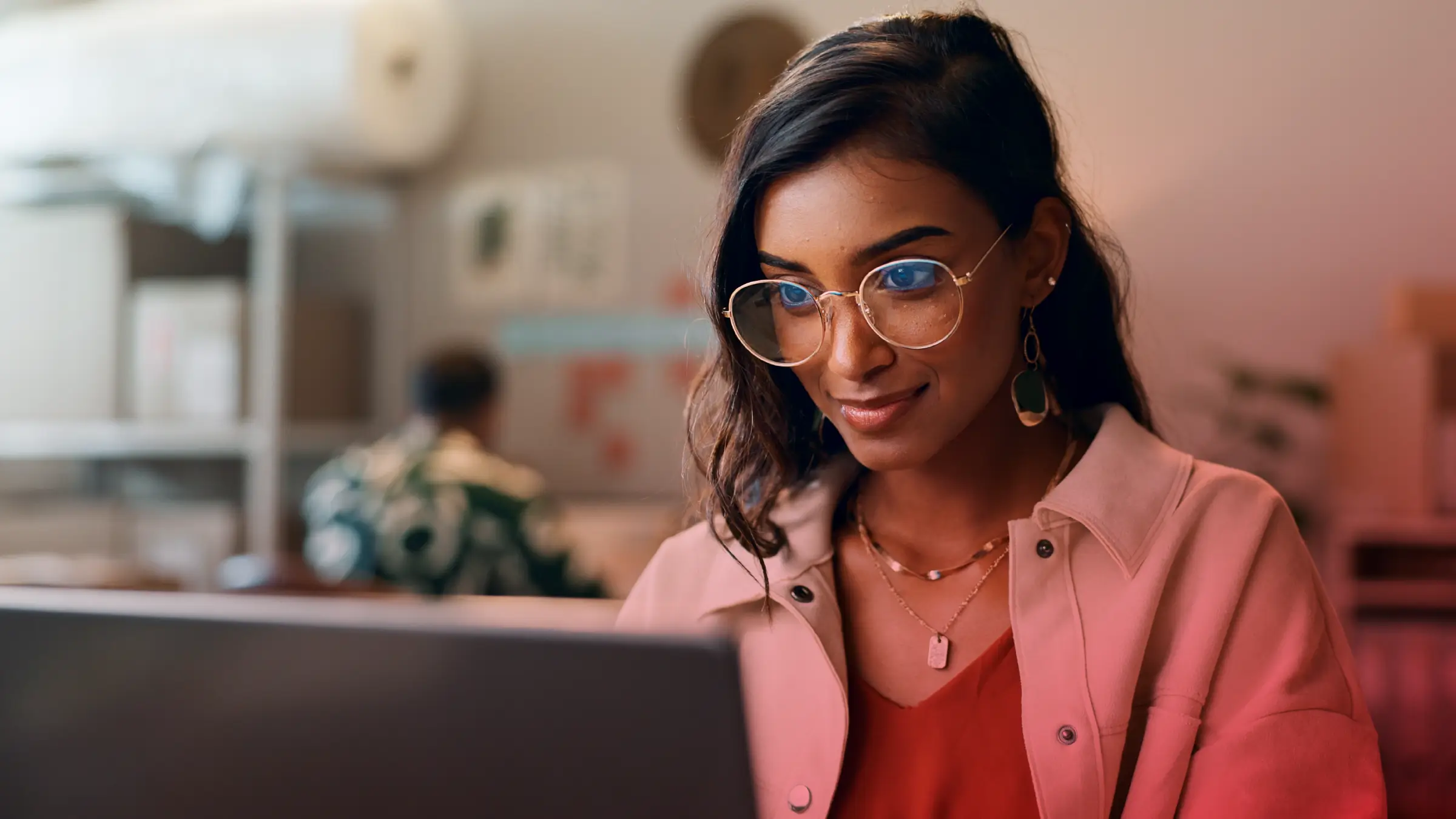 Woman working on a product requirements document (PRD) in an office.